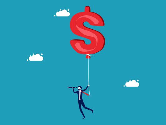 businessman holding a big dollar sign on a string