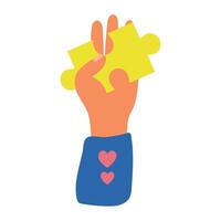 A hand holding a piece of puzzle with a heart vector