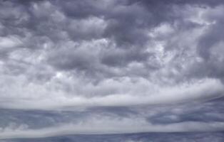 gloomy gray low clouds, dramatic sky background photo
