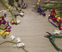 a table with a bunch of flowers and a pair of scissors photo