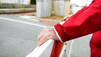 The Hands Of A Man On The Train Railing photo