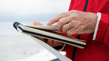 Man Turning Pages Of The Block Notes photo