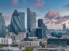 Aerial panoramic view of the city of London business center. Close up view of the riverside near river Thames. photo