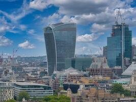 Aerial panoramic view of the city of London business center. Close up view of the riverside near river Thames. photo