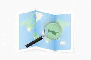 Enlarge Uzbekistan with a magnifying glass on a folded map of the world. vector