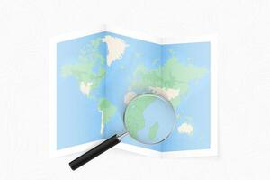 Enlarge Comoros with a magnifying glass on a folded map of the world. vector