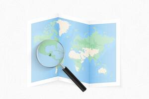 Enlarge Guatemala with a magnifying glass on a folded map of the world. vector
