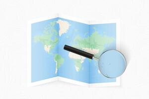 Enlarge Tonga with a magnifying glass on a folded map of the world. vector