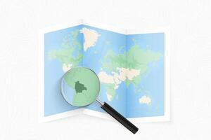 Enlarge Bolivia with a magnifying glass on a folded map of the world. vector