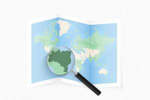 Enlarge Brazil with a magnifying glass on a folded map of the world. vector