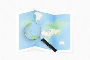Enlarge Haiti with a magnifying glass on a folded map of the world. vector