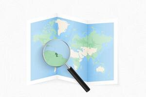 Enlarge Guyana with a magnifying glass on a folded map of the world. vector