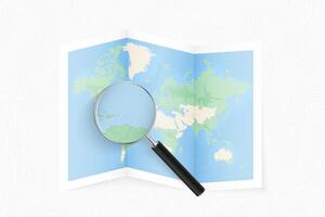 Enlarge Antigua and Barbuda with a magnifying glass on a folded map of the world. vector