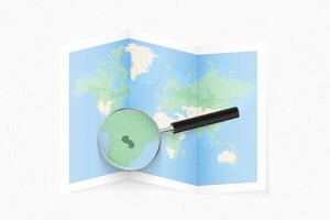 Enlarge Paraguay with a magnifying glass on a folded map of the world. vector