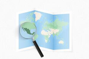 Enlarge Mexico with a magnifying glass on a folded map of the world. vector