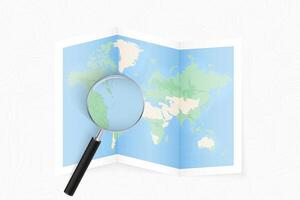 Enlarge Dominica with a magnifying glass on a folded map of the world. vector