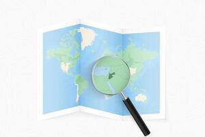 Enlarge Jordan with a magnifying glass on a folded map of the world. vector