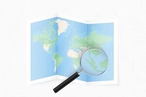 Enlarge Singapore with a magnifying glass on a folded map of the world. vector