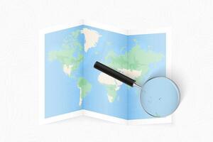 Enlarge Fiji with a magnifying glass on a folded map of the world. vector