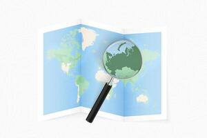 Enlarge Russia with a magnifying glass on a folded map of the world. vector