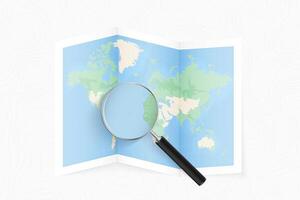 Enlarge Cape Verde with a magnifying glass on a folded map of the world. vector