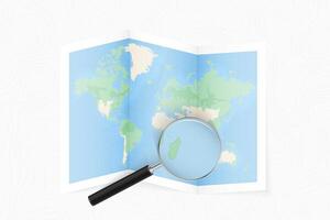 Enlarge Mauritius with a magnifying glass on a folded map of the world. vector