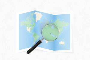 Enlarge Kuwait with a magnifying glass on a folded map of the world. vector