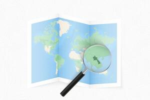 Enlarge Laos with a magnifying glass on a folded map of the world. vector