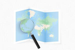 Enlarge The Bahamas with a magnifying glass on a folded map of the world. vector