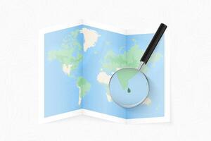 Enlarge Sri Lanka with a magnifying glass on a folded map of the world. vector