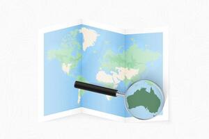 Enlarge Australia with a magnifying glass on a folded map of the world. vector