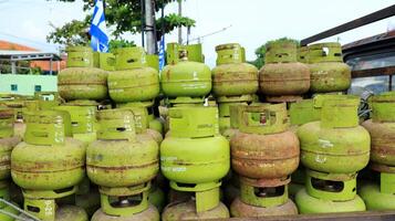 Stack of 3 kilo green gas cylinders, LPG photo