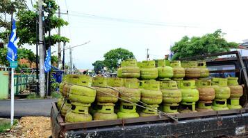 Stack of 3 kilo green gas cylinders, LPG photo