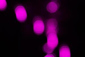Blurred lights with purple bokeh effect Background photo