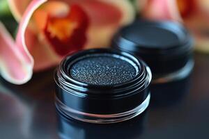 Sleek black eyeliner pots, with blurred orchids in the background. Professional shot showcasing the elegant design and high-quality finish of the eyeliner. photo
