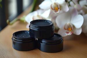 Sleek black eyeliner pots, with blurred orchids in the background. Professional shot showcasing the elegant design and high-quality finish of the eyeliner. photo