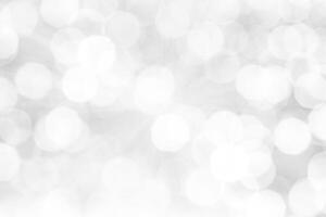 Blurred abstract background. Abstract white and silver blurred background with glittering lights for display. photo