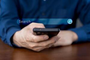 Close-up of hand a man using a mobile phone search for information interest on search engine website photo