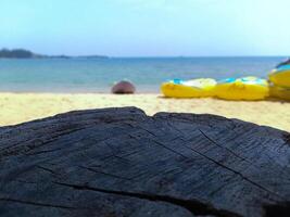 Empty wooden planks with blur beach and canoes on background, can be used for product placement photo