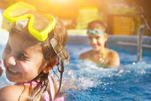 Children playing in pool. Two little girls having fun in the pool photo
