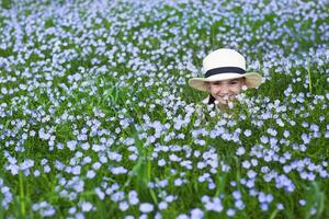Portrait of a little funny girl in linen field photo
