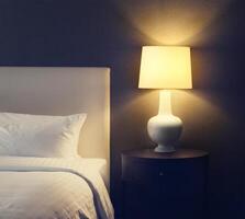 Hotel bedroom with lamp and hotel bed with space for text photo