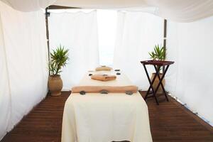 Massage table in the spa on the beach photo