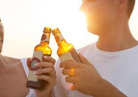 Couple on the beach having party, drinking and having fun photo