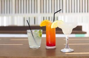 Cocktail glasses on wooden background photo