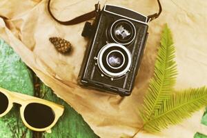 Old retro camera with sunglasses abstract background photo