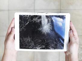 Damaged tablet computer lcd display on the floor photo