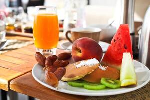 Breakfast in the morning with pancaces and fruits photo