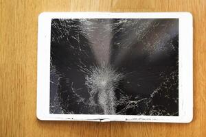 Damaged tablet computer lcd display on the floor photo