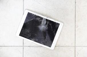 Damaged tablet computer lcd display on the floor photo